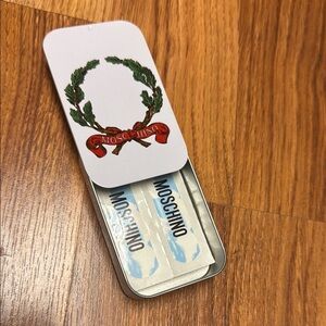 Moschino set of 10 Band-Aids in the metal case.